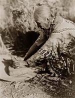Woman Grinding Corn