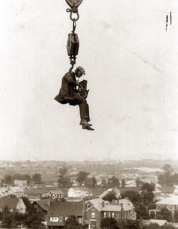 Photographer with camera suspended